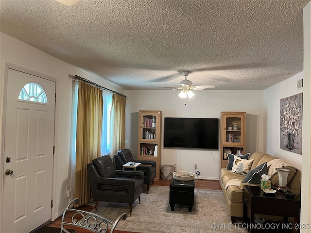 4908 N Xanthus Ave, Tulsa, OK 74130 - living area with ceiling fan, a textured ceiling, and wood finished floors