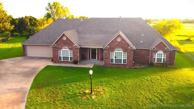 7054 E 149th St, Collinsville, OK 74021 - view of front of property with concrete driveway, brick siding, a front yard, and a garage