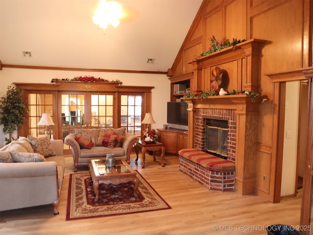 7054 E 149th St, Collinsville, OK 74021 - living room with light wood-style floors, ornamental molding, a fireplace, and vaulted ceiling