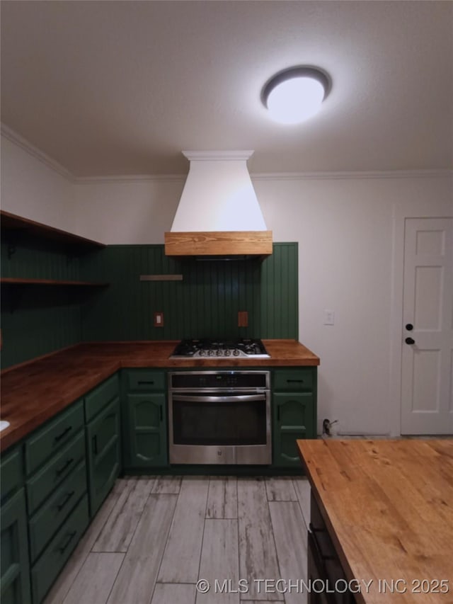 804 W Glendale St, Broken Arrow, OK 74011 - kitchen with wooden counters, green cabinetry, appliances with stainless steel finishes, custom exhaust hood, and crown molding