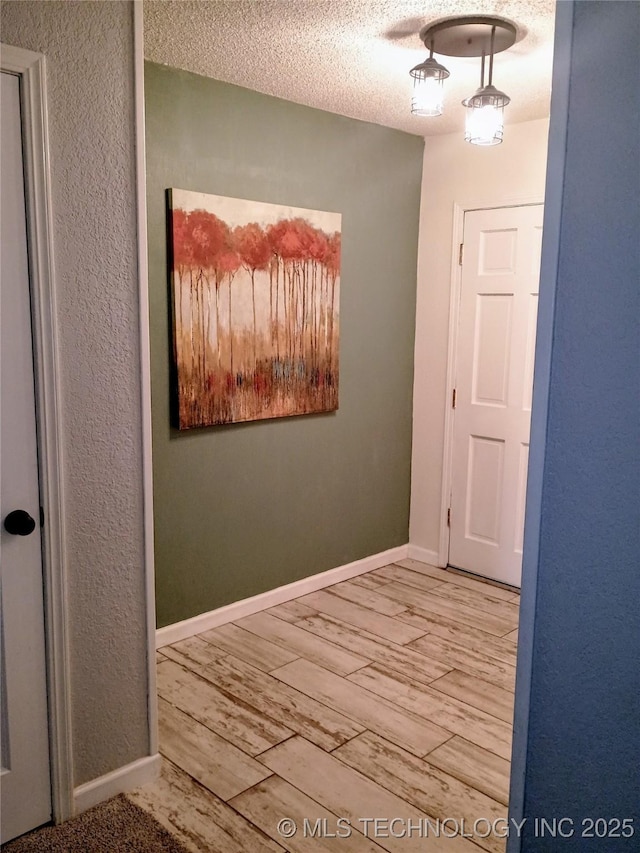 804 W Glendale St, Broken Arrow, OK 74011 - hall with wood finished floors, a textured ceiling, and a textured wall