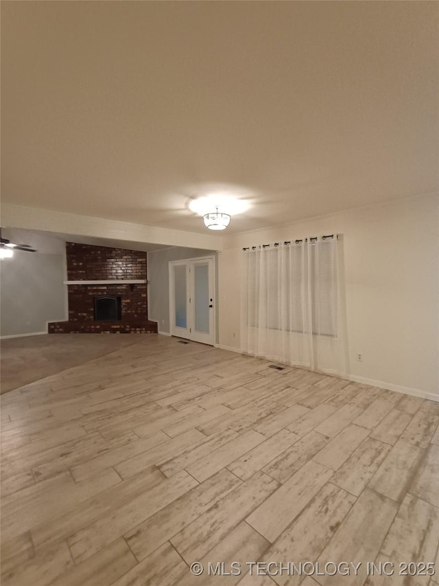804 W Glendale St, Broken Arrow, OK 74011 - unfurnished living room featuring a brick fireplace and wood finished floors