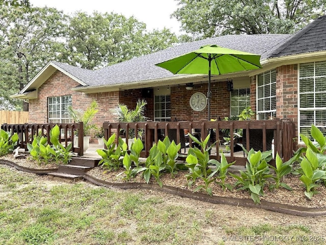 417292 E 1145th Rd, Eufaula, OK 74432 - rear view of property with brick siding, a wooden deck, and roof with shingles