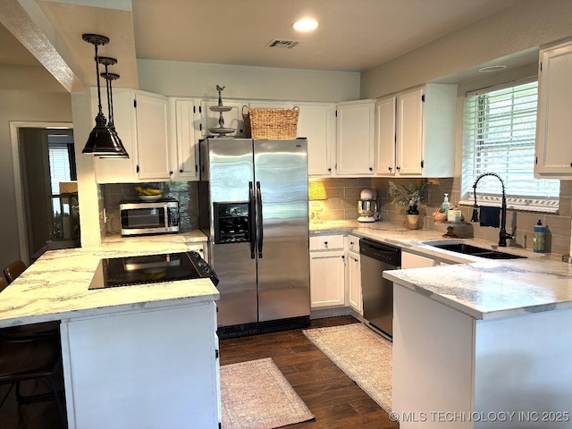 417292 E 1145th Rd, Eufaula, OK 74432 - kitchen featuring appliances with stainless steel finishes, a peninsula, white cabinets, dark wood finished floors, and recessed lighting