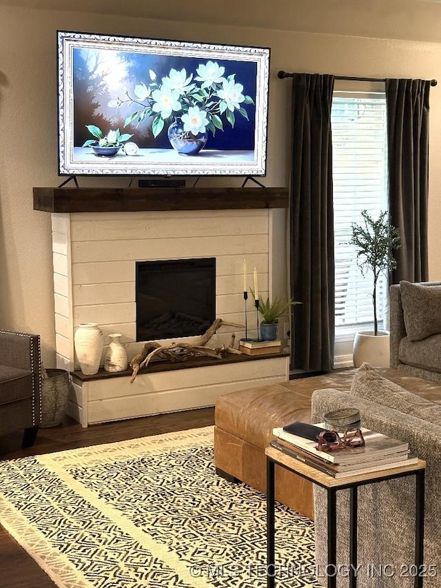 417292 E 1145th Rd, Eufaula, OK 74432 - living area featuring wood finished floors, plenty of natural light, and a glass covered fireplace