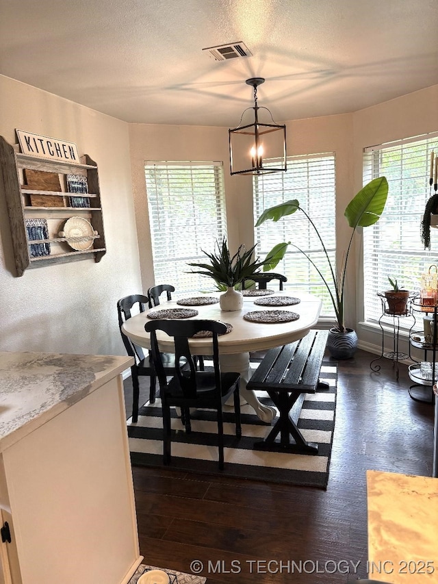 417292 E 1145th Rd, Eufaula, OK 74432 - dining area featuring a chandelier, dark wood-type flooring, and a textured ceiling