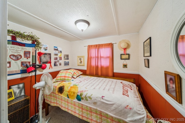 2219 Hart Cove Dr, Grove, OK 74344 - bedroom with a wainscoted wall, a textured ceiling, and carpet