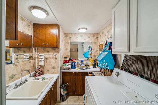 2219 Hart Cove Dr, Grove, OK 74344 - laundry area featuring washer / dryer, light tile patterned floors, a textured ceiling, and wallpapered walls