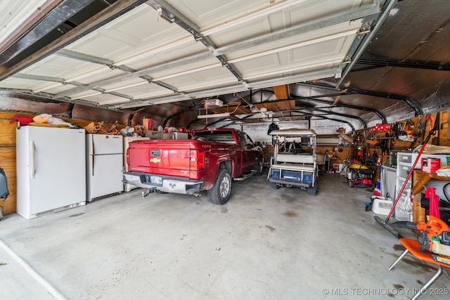 2219 Hart Cove Dr, Grove, OK 74344 - garage with freestanding refrigerator