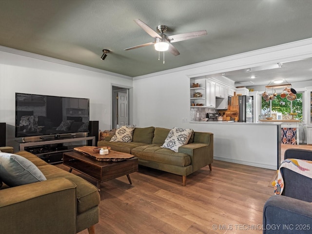 105 Quail Creek Ln, Skiatook, OK 74070 - living area featuring light wood-style flooring, ceiling fan, and crown molding