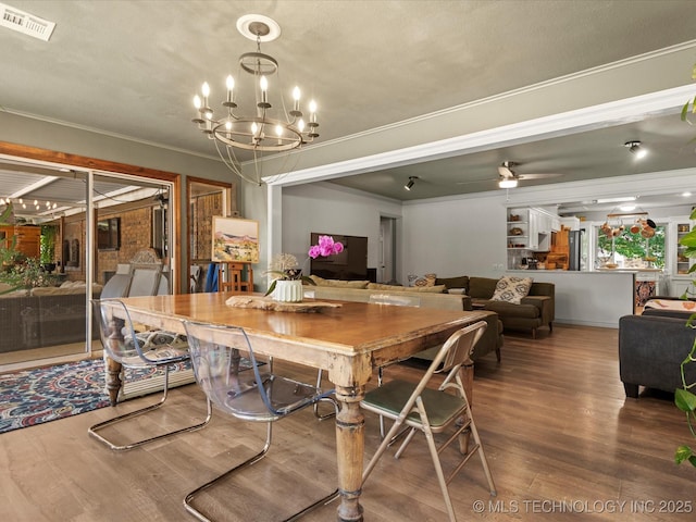 105 Quail Creek Ln, Skiatook, OK 74070 - dining room featuring wood finished floors, crown molding, a chandelier, and ceiling fan