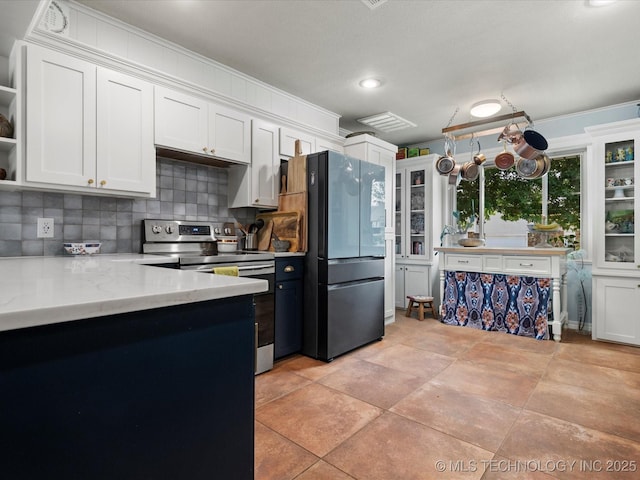 105 Quail Creek Ln, Skiatook, OK 74070 - kitchen featuring electric range, tasteful backsplash, white cabinetry, freestanding refrigerator, and open shelves