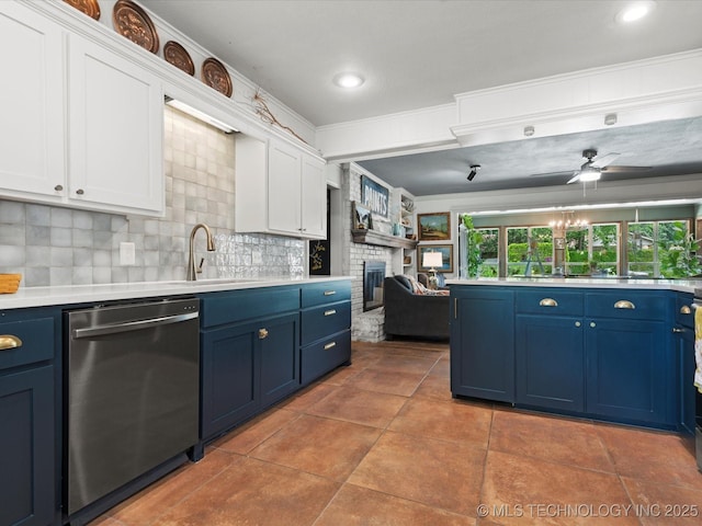 105 Quail Creek Ln, Skiatook, OK 74070 - kitchen with stainless steel dishwasher, blue cabinets, white cabinets, light countertops, and a brick fireplace