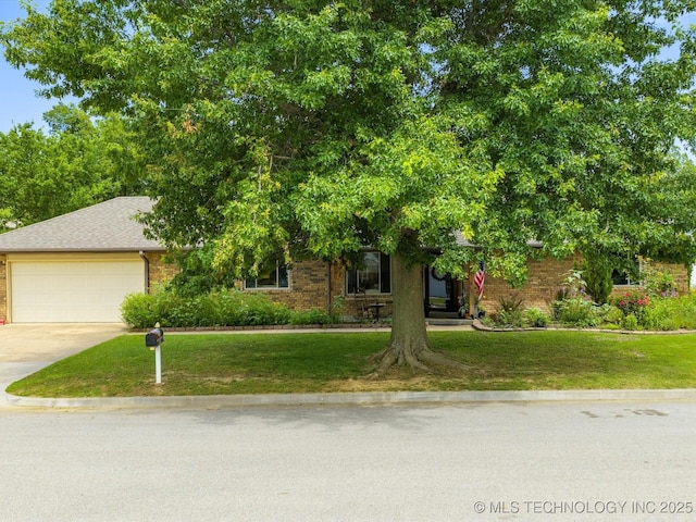 105 Quail Creek Ln, Skiatook, OK 74070 - view of property hidden behind natural elements featuring driveway, an attached garage, a front yard, and brick siding