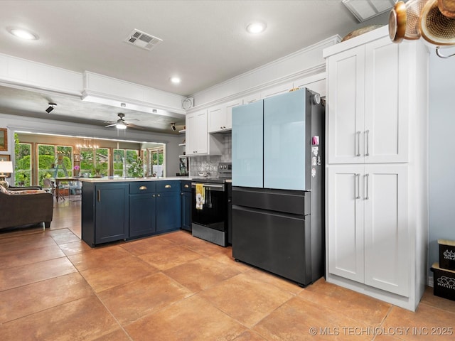 105 Quail Creek Ln, Skiatook, OK 74070 - kitchen featuring freestanding refrigerator, electric range, a peninsula, white cabinetry, and open shelves