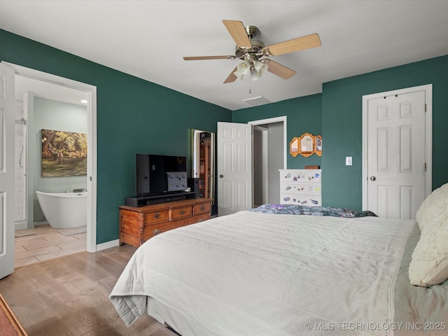 105 Quail Creek Ln, Skiatook, OK 74070 - bedroom with wood finished floors, ceiling fan, and ensuite bathroom