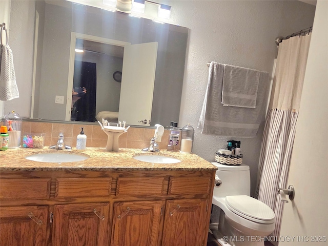 76654 S 4695, Stilwell, OK 74960 - bathroom featuring double vanity, a textured wall, and tasteful backsplash