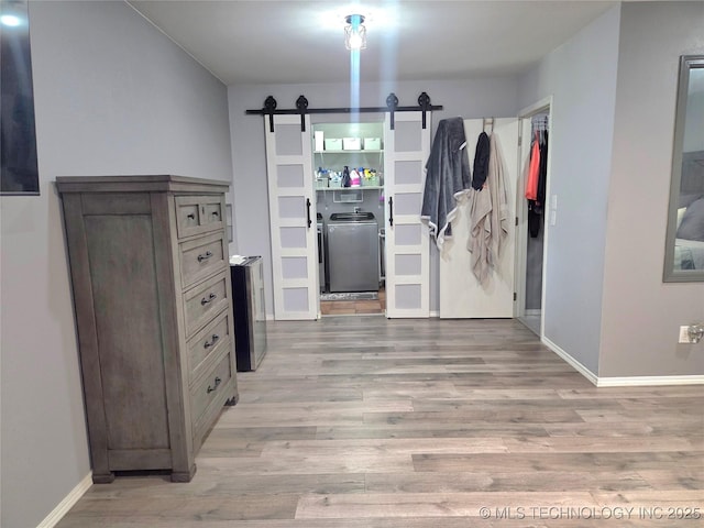 76654 S 4695, Stilwell, OK 74960 - interior space with a barn door, light wood finished floors, and washer / clothes dryer