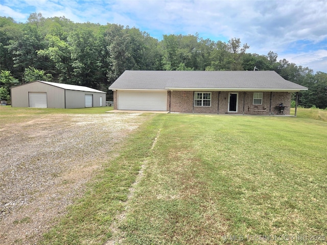 76654 S 4695, Stilwell, OK 74960 - view of front of home with driveway, a front lawn, brick siding, an outdoor structure, and a garage