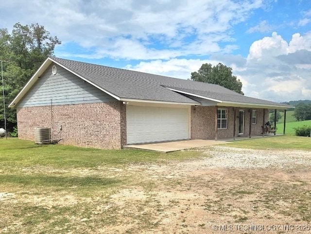 76654 S 4695, Stilwell, OK 74960 - view of side of home with an attached garage, driveway, a yard, and brick siding