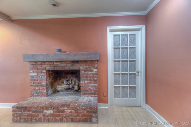 8109 E 31st Pl, Tulsa, OK 74145 - unfurnished living room featuring crown molding, wood finished floors, and a brick fireplace
