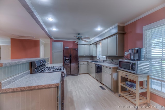 8109 E 31st Pl, Tulsa, OK 74145 - kitchen with stainless steel appliances, light countertops, a ceiling fan, ornamental molding, and light wood finished floors