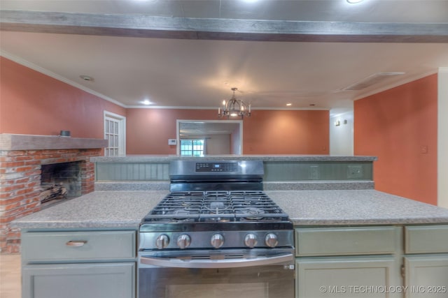 8109 E 31st Pl, Tulsa, OK 74145 - kitchen featuring gas range, light countertops, ornamental molding, recessed lighting, and a fireplace