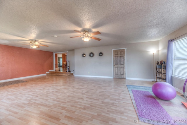 8109 E 31st Pl, Tulsa, OK 74145 - exercise area featuring ceiling fan, a textured ceiling, and light wood finished floors