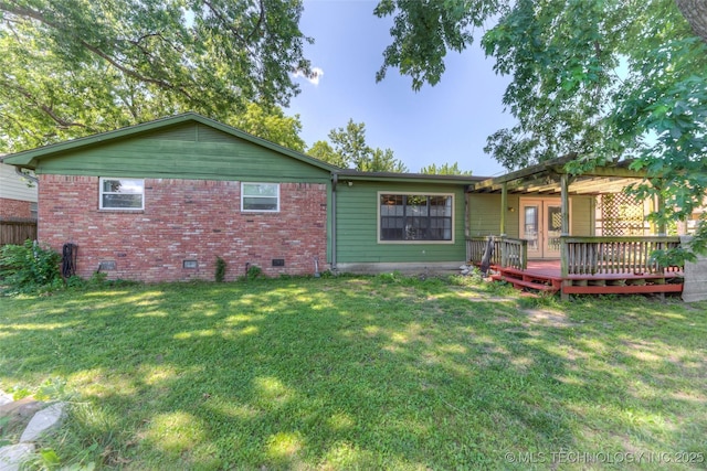 8109 E 31st Pl, Tulsa, OK 74145 - rear view of house featuring a wooden deck, crawl space, brick siding, and a yard