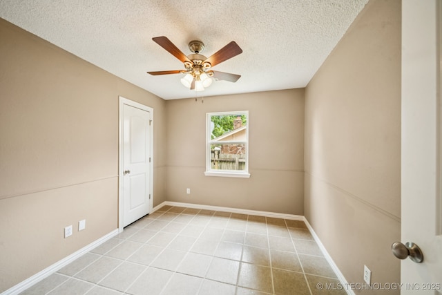 106 E 21st St, Owasso, OK 74055 - tiled spare room with a textured ceiling and ceiling fan