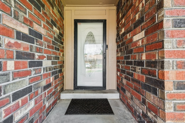 106 E 21st St, Owasso, OK 74055 - doorway to property with brick siding
