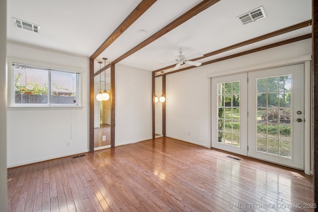1234 S 101st E Ave, Tulsa, OK 74128 - empty room featuring healthy amount of natural light, hardwood / wood-style flooring, beamed ceiling, and ceiling fan