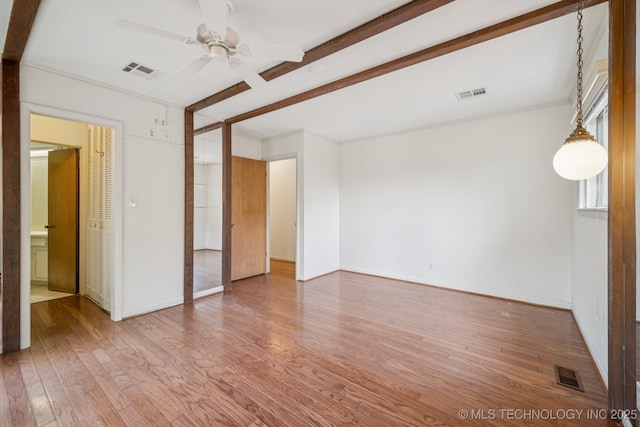 1234 S 101st E Ave, Tulsa, OK 74128 - unfurnished room with wood finished floors, a ceiling fan, and beam ceiling
