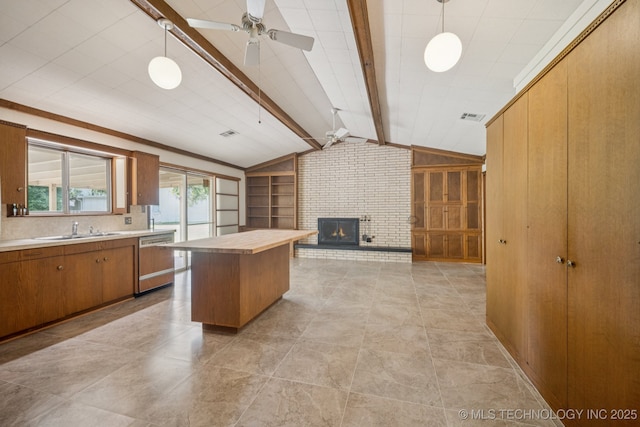 1234 S 101st E Ave, Tulsa, OK 74128 - kitchen with dishwashing machine, a ceiling fan, open floor plan, a fireplace, and brown cabinets