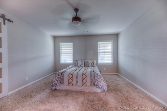 3711 S 151st E Ave, Tulsa, OK 74134 - bedroom with multiple windows, carpet floors, ceiling fan, and a barn door