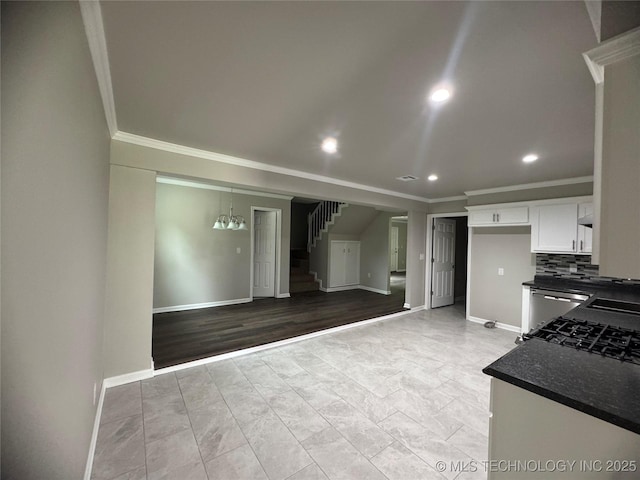 1704 Town And Country Rd, Sand Springs, OK 74063 - kitchen with crown molding, dark countertops, recessed lighting, white cabinets, and light marble finish floors
