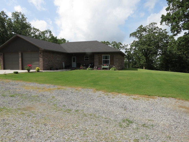 504 Blocker Rd, Mcalester, OK 74501 - ranch-style house featuring a front lawn, brick siding, an attached garage, and driveway