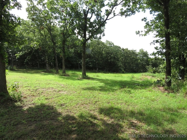 504 Blocker Rd, Mcalester, OK 74501 - view of grassy yard with a forest view