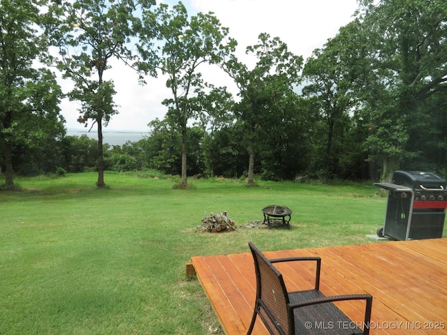 504 Blocker Rd, Mcalester, OK 74501 - view of grassy yard with an outdoor fire pit and a deck