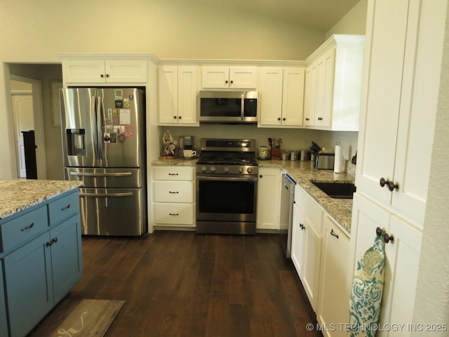 504 Blocker Rd, Mcalester, OK 74501 - kitchen with appliances with stainless steel finishes, vaulted ceiling, white cabinetry, and light stone counters