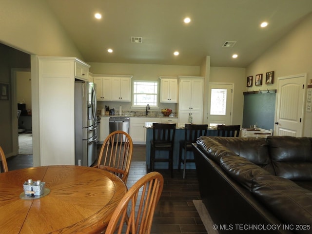 504 Blocker Rd, Mcalester, OK 74501 - dining room featuring lofted ceiling, recessed lighting, and dark wood-type flooring