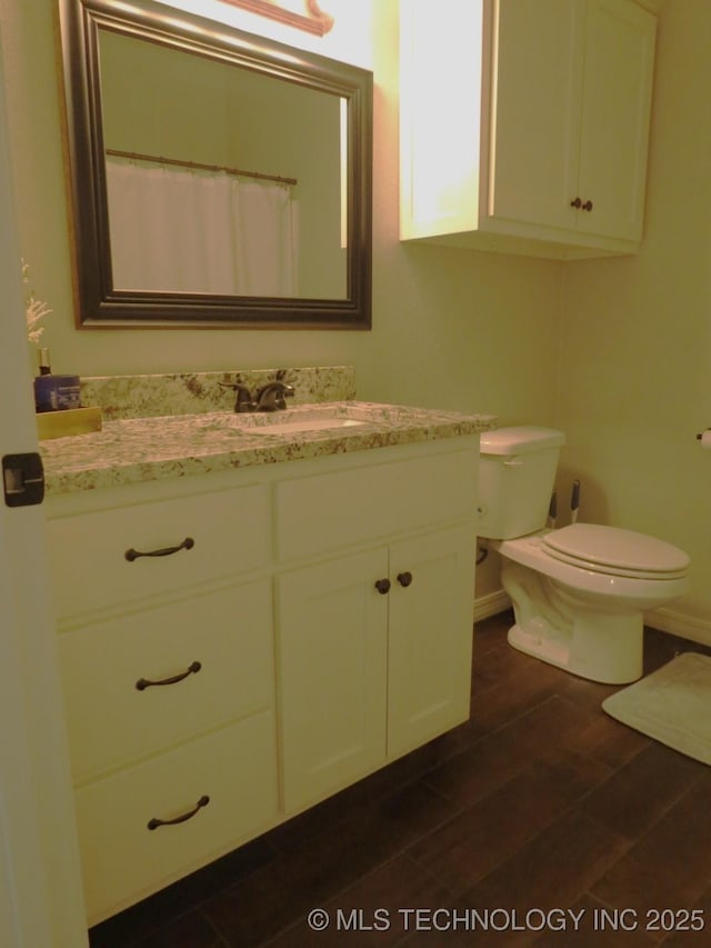 504 Blocker Rd, Mcalester, OK 74501 - bathroom featuring vanity and wood finished floors