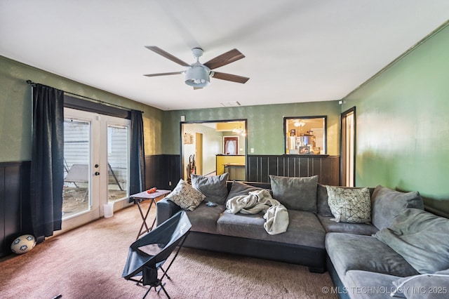 2548 Tull Pl, Muskogee, OK 74403 - living area featuring light colored carpet, a wainscoted wall, and a ceiling fan