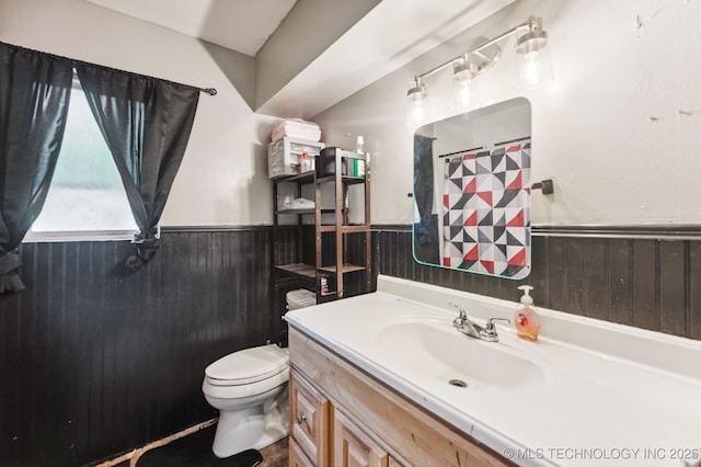 2548 Tull Pl, Muskogee, OK 74403 - full bathroom with a wainscoted wall, vanity, a shower with shower curtain, and wood walls