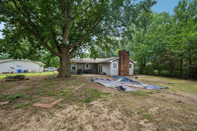2548 Tull Pl, Muskogee, OK 74403 - rear view of property with a chimney and a patio