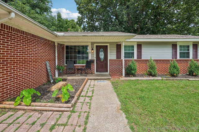 2548 Tull Pl, Muskogee, OK 74403 - property entrance with brick siding, a porch, and a yard