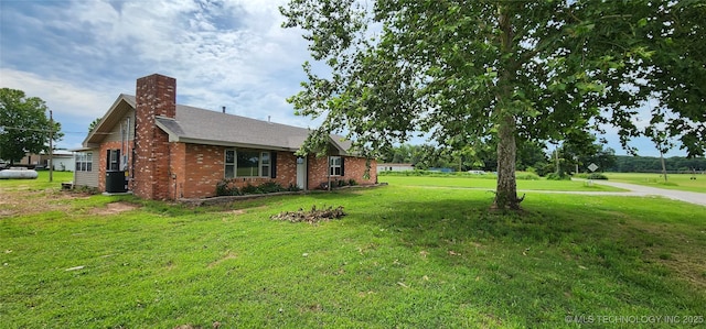 14505 S 145th E Ave, Bixby, OK 74008 - view of side of property with a yard, a chimney, and brick siding