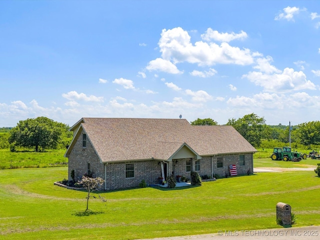 16145 Ew 255 Rd, Nowata, OK 74048 - view of front facade featuring a front yard, brick siding, and a shingled roof