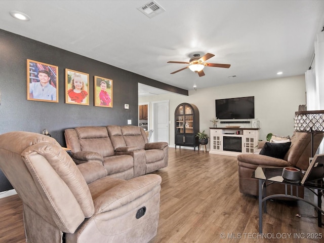 16145 Ew 255 Rd, Nowata, OK 74048 - living area featuring ceiling fan, wood finished floors, recessed lighting, and a glass covered fireplace