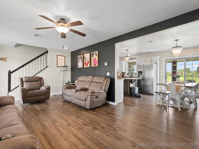 16145 Ew 255 Rd, Nowata, OK 74048 - living area featuring a ceiling fan, dark wood-style floors, and stairs